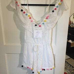 Off-shoulder White romper with colorful Pom poms